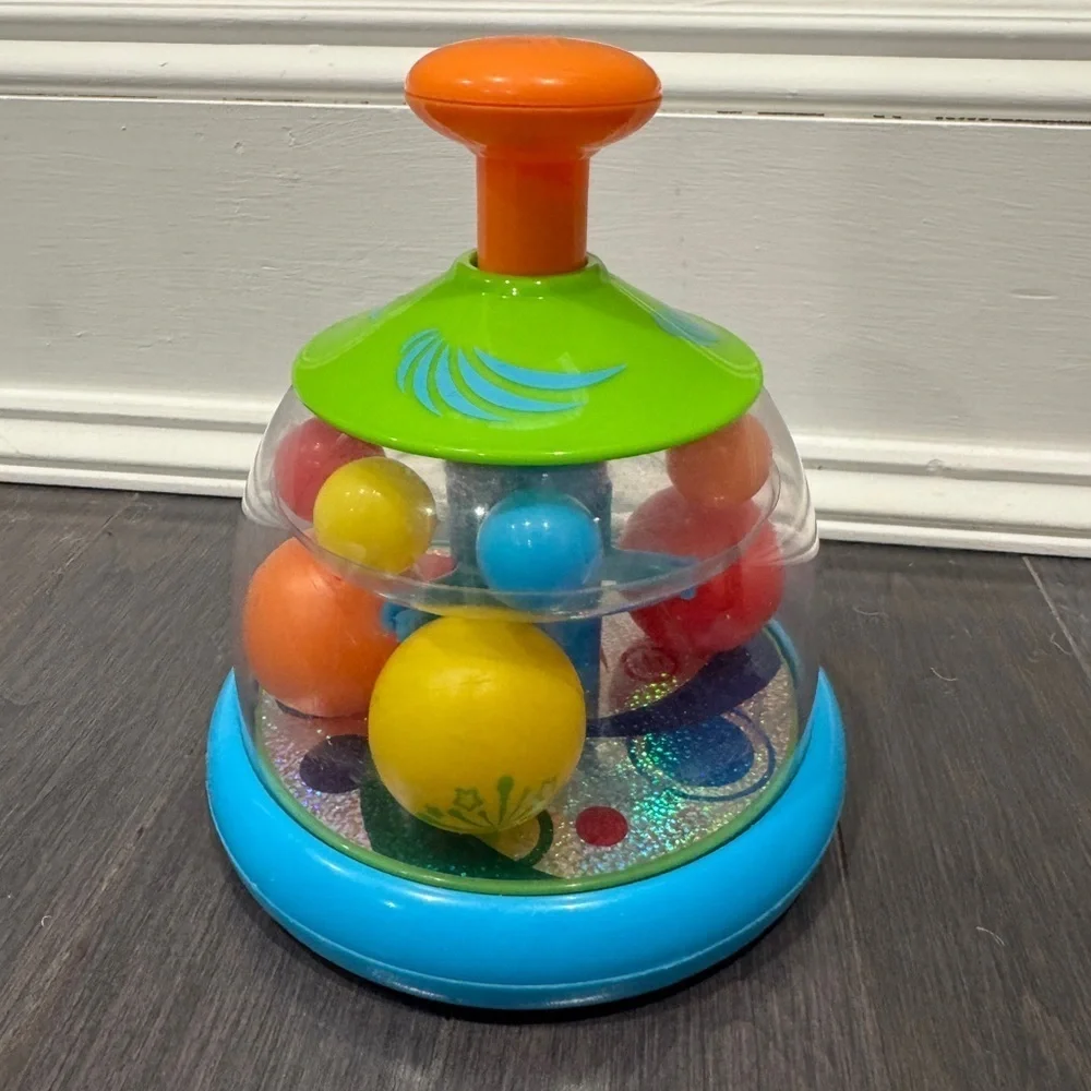 Orange and Green Press and Spin Learning Baby Toy